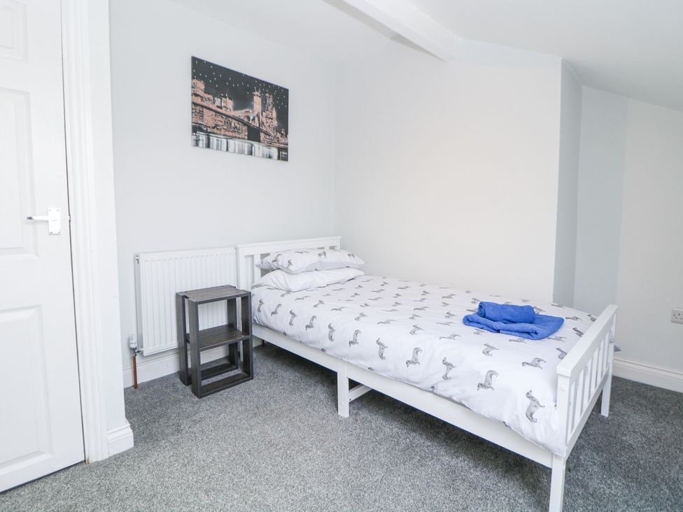 A bedroom with a bed and nightstand at 15 South Avenue Mews Buxton