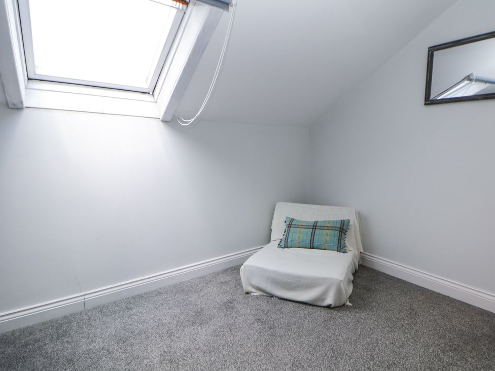 A loft with a chair and a skylight at 15 South Avenue Mews Buxton
