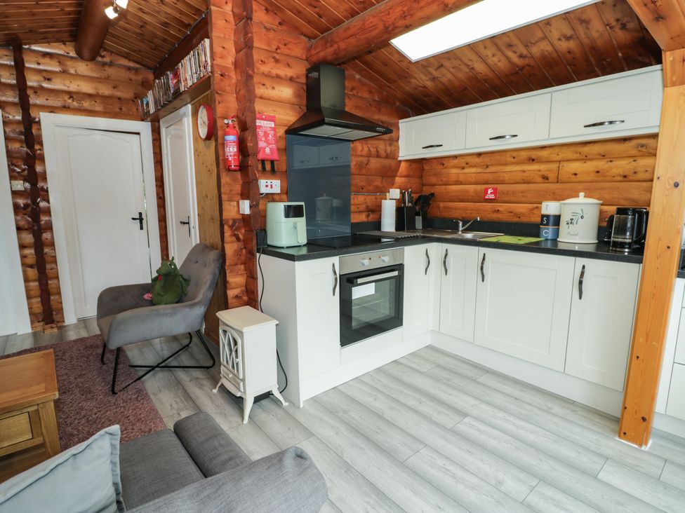 A kitchen with appliances and seating area at Babbling Brook in Bron Aber near Blaenau Ffestiniog