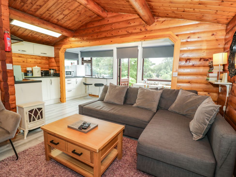 A living room with a sofa and coffee table at Babbling Brook in Bron Aber near Blaenau Ffestiniog