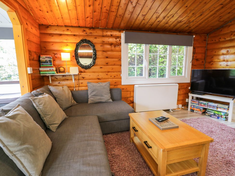 A snug with a sofa and television at Babbling Brook in Bron Aber near Blaenau Ffestiniog