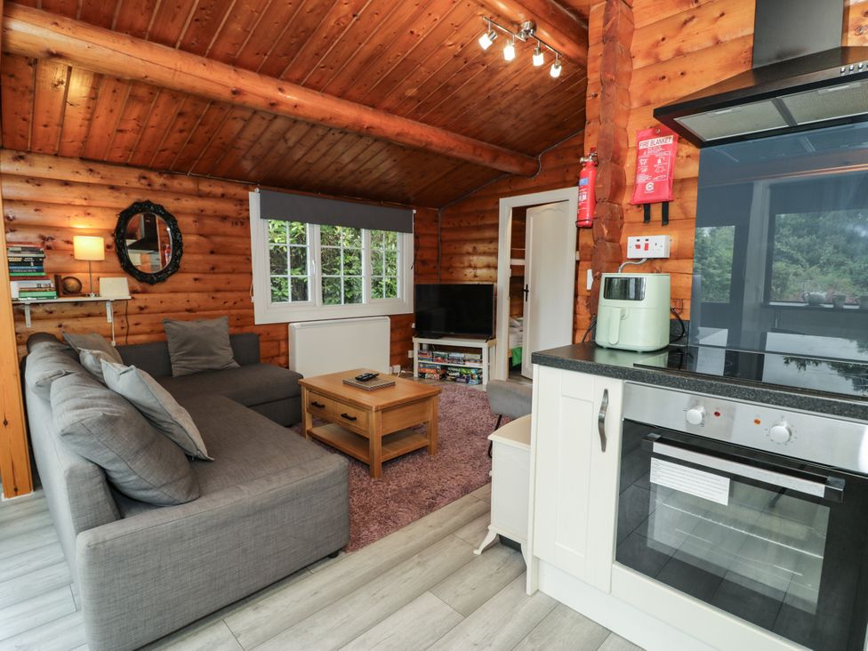 A snug area with a sofa and TV at Babbling Brook in Bron Aber near Blaenau Ffestiniog