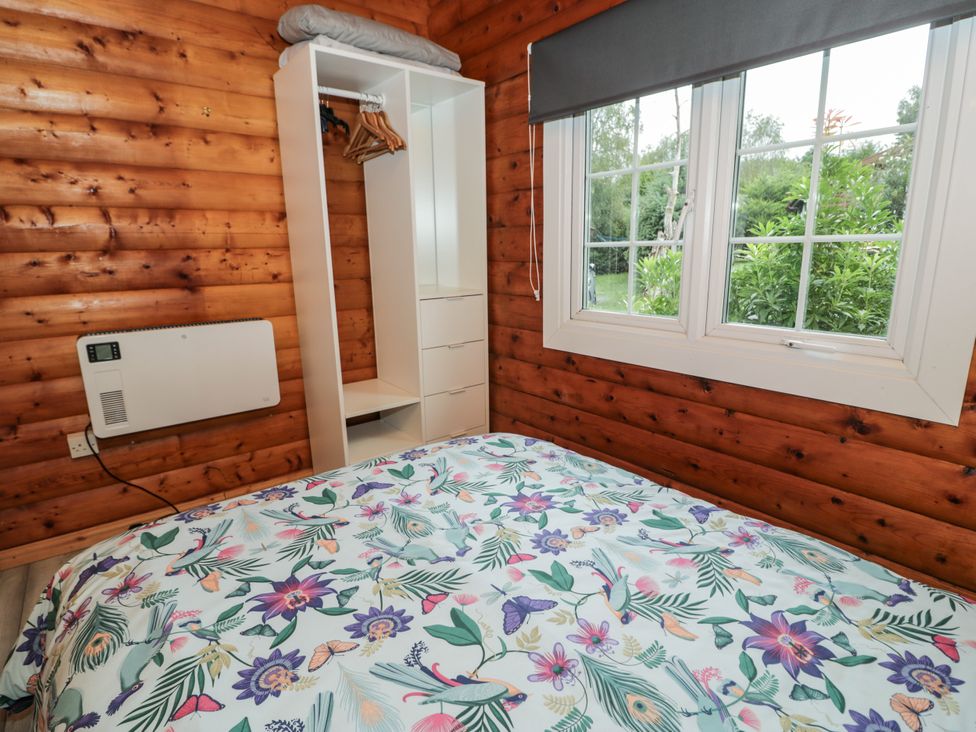 A bedroom with a bed and closet at Babbling Brook near Blaenau Ffestiniog