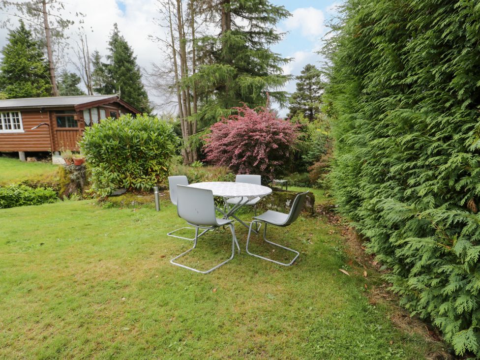 A table with chairs in a garden at Babbling Brook in Bron Aber near Blaenau Ffestiniog