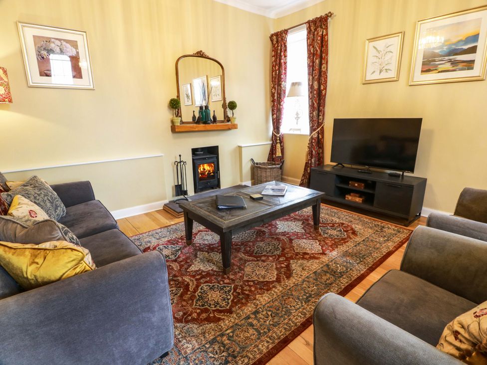 A living room with a sofa and coffee table at Clocktower - Culzean Castle in Maybole