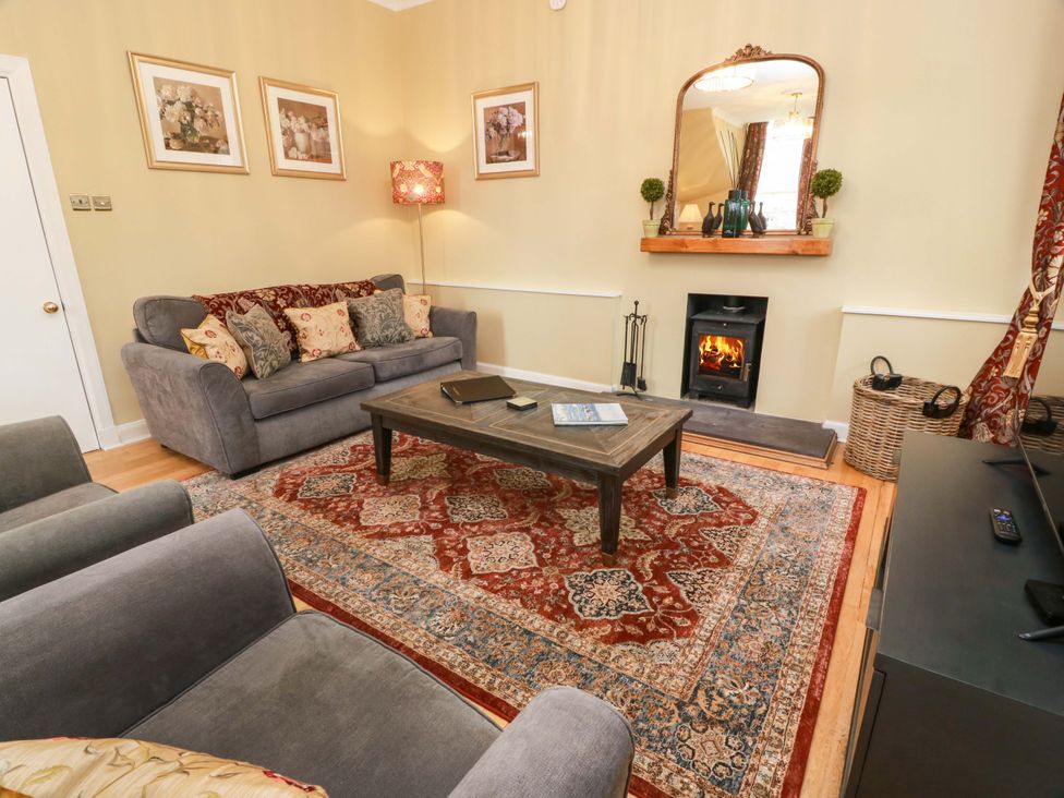 A living room with a sofa and coffee table at Clocktower - Culzean Castle in Maybole