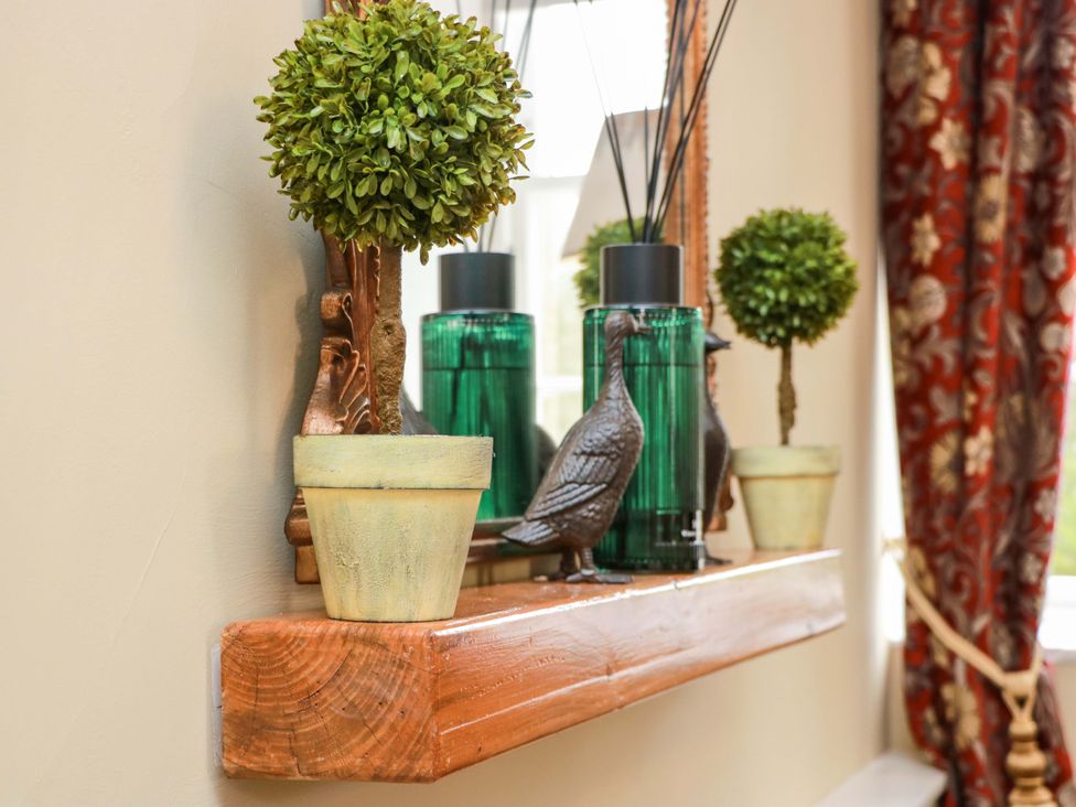 A decorative shelf with faux plants and ornaments at Clocktower - Culzean Castle Maybole