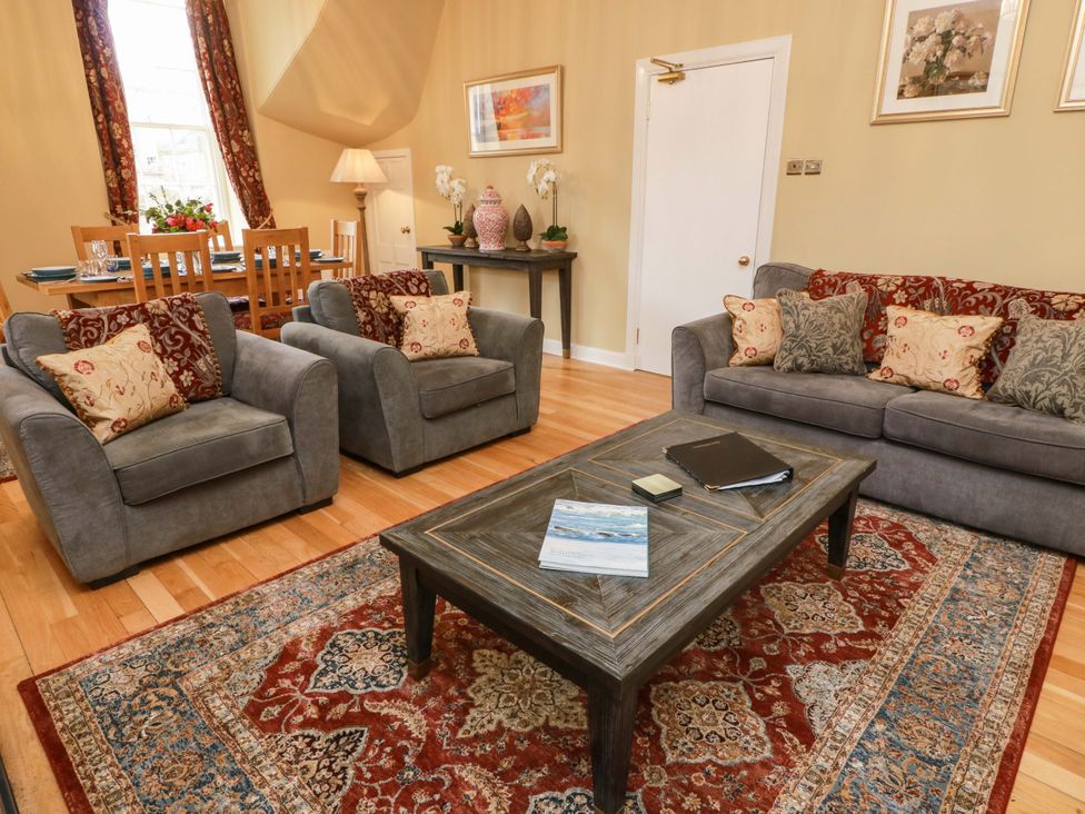 A living room with sofa and armchairs at Clocktower - Culzean Castle Maybole