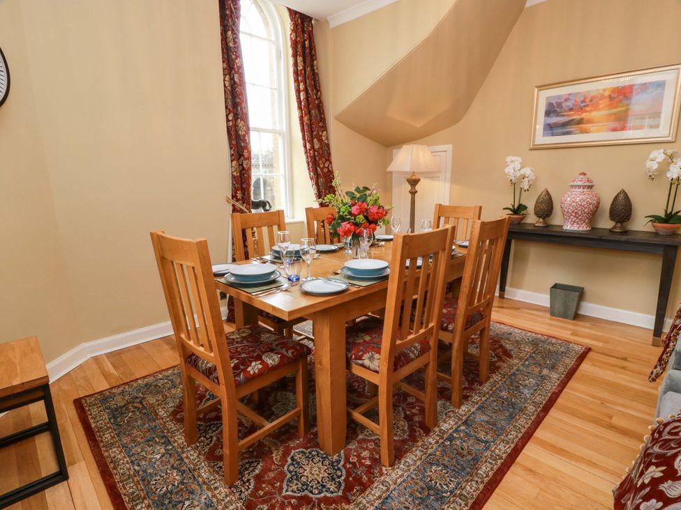 A dining room with a table set for dinner at Clocktower - Culzean Castle in Maybole