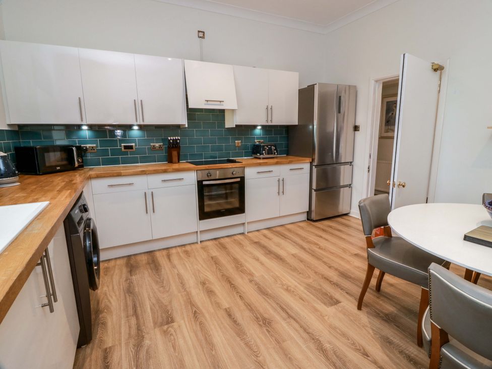 A kitchen with appliances and a table at Clocktower - Culzean Castle Maybole