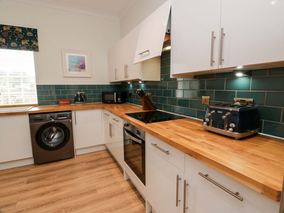 A kitchen with appliances and countertops at Clocktower - Culzean Castle Maybole