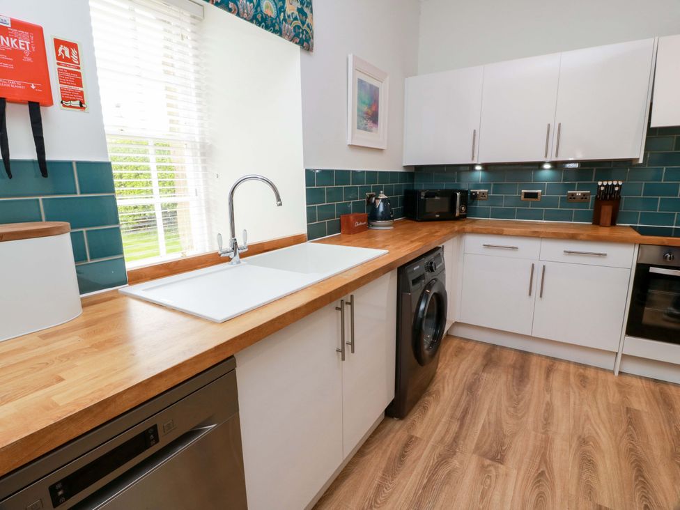 A kitchen with appliances and cabinets at Clocktower - Culzean Castle in Maybole