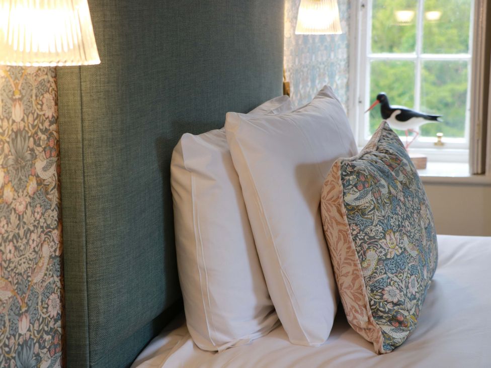 A bedroom with pillows on a bed at Clocktower - Culzean Castle Maybole