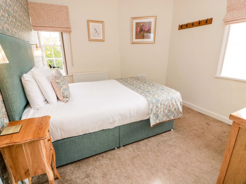 A bedroom with a bed and nightstand at Clocktower - Culzean Castle in Maybole