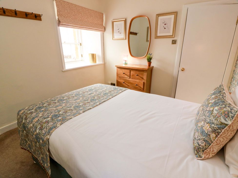 A bedroom with a bed and a drawer chest at Clocktower - Culzean Castle in Maybole