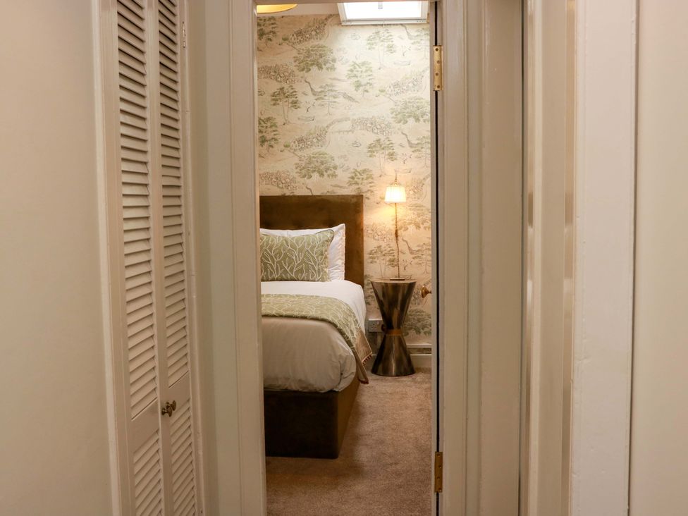 A bedroom view with a bed and lamp at Clocktower - Culzean Castle in Maybole