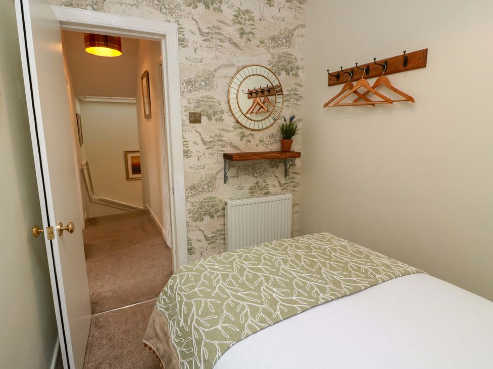 A bedroom with a bed and a mirror at Clocktower - Culzean Castle in Maybole