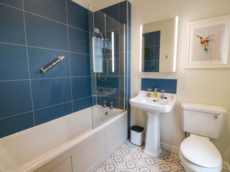 A bathroom with a bathtub, shower, sink, and toilet at Clocktower - Culzean Castle Maybole