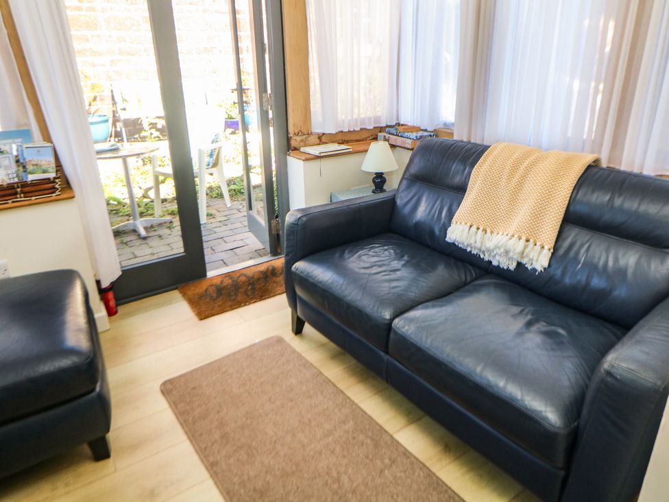 A snug with a sofa and a door leading to outdoor area at The Netty in Flash