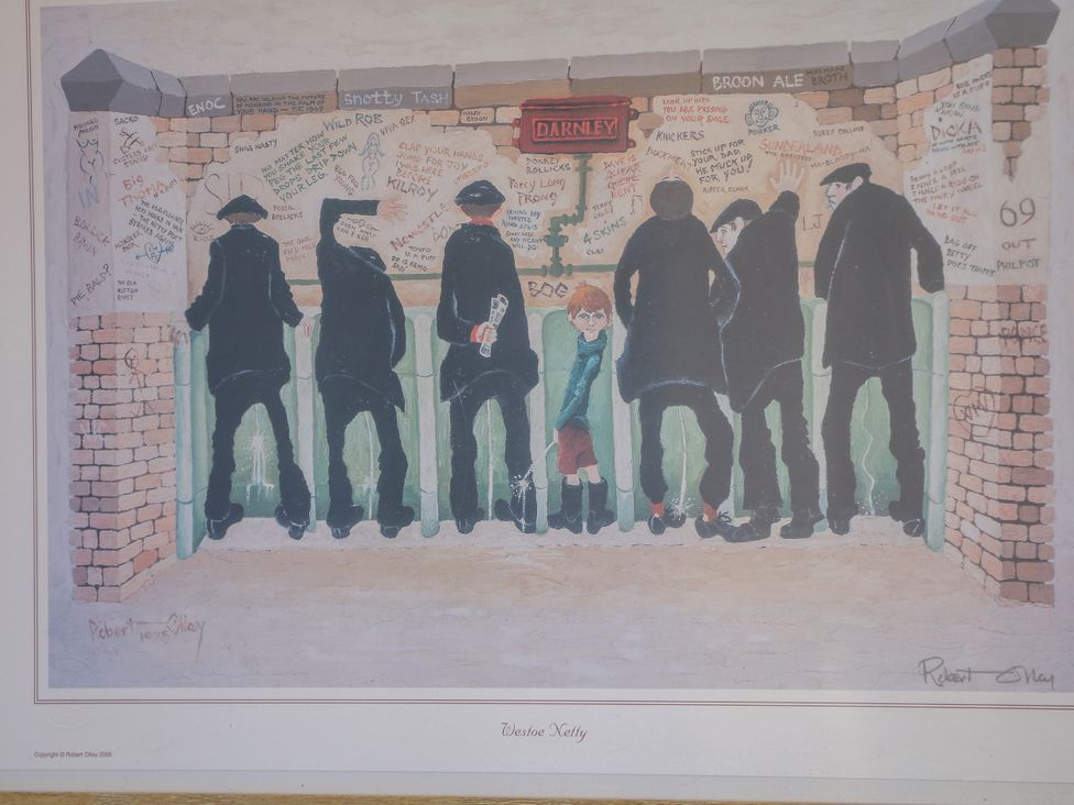 An outdoor scene with men and a boy standing by a wall at The Netty in Flash