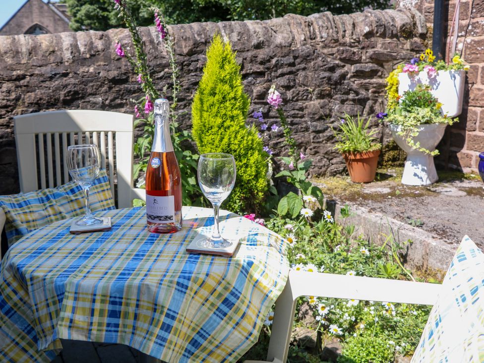 A table set with wine glasses and a bottle at The Netty in Flash