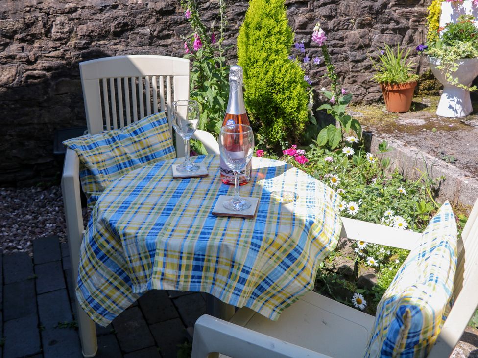 A garden table set with champagne and glasses at The Netty in Flash
