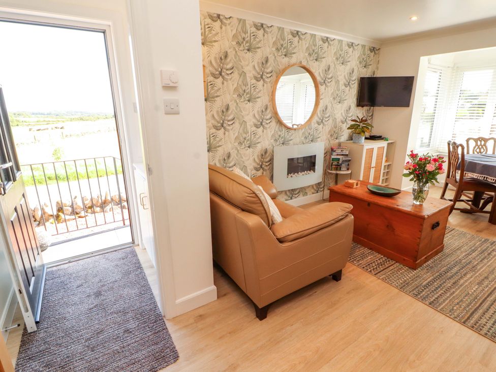A living room with a sofa and coffee table at The Paddock in Kirkcowan