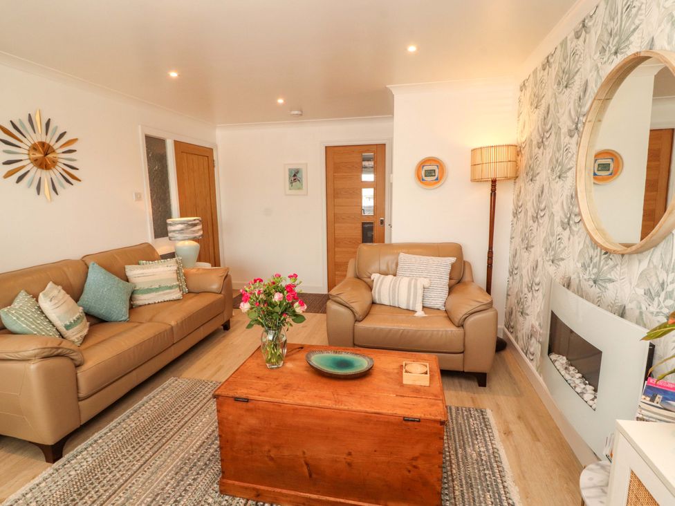 A living room with sofas and a coffee table at The Paddock in Kirkcowan
