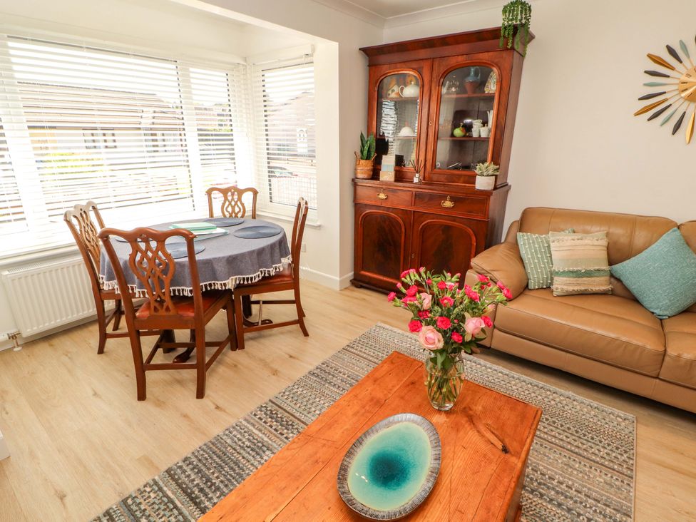 A dining room with a table and chairs at The Paddock in Kirkcowan