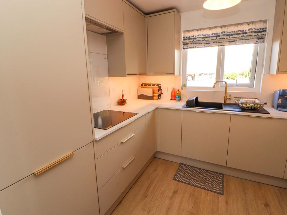 A kitchen with cabinets and sink at The Paddock in Kirkcowan