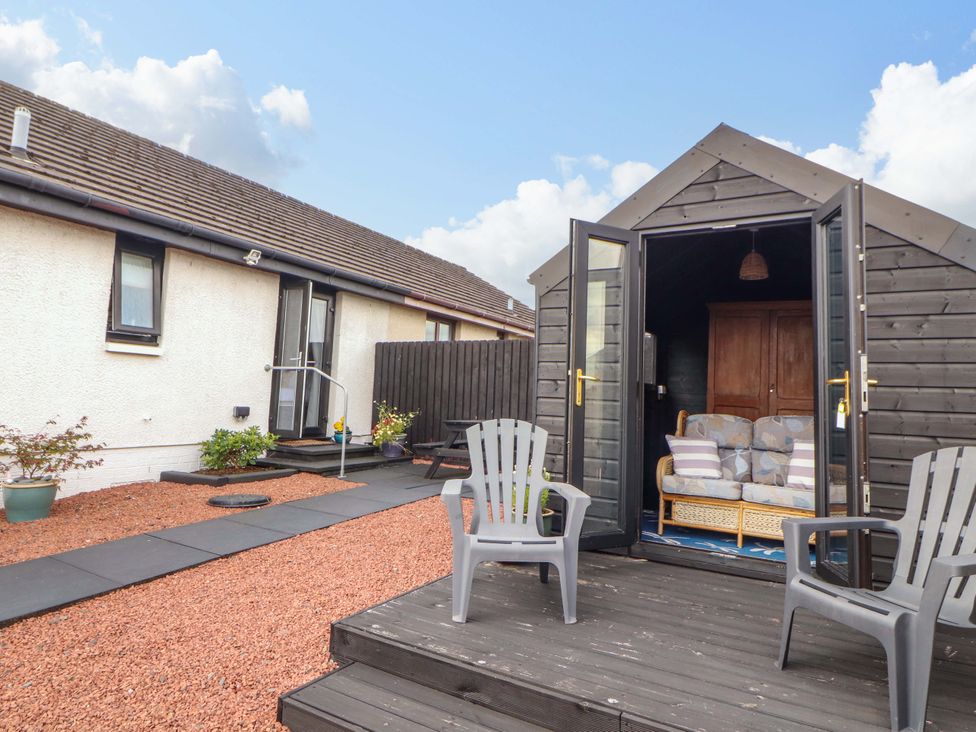 An outdoor area featuring a shed, chairs, and a pathway at The Paddock in Kirkcowan