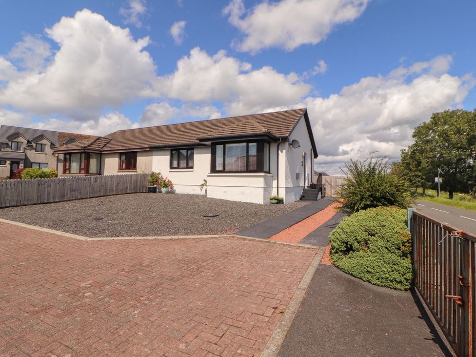 A house with a driveway and garden at The Paddock in Kirkcowan