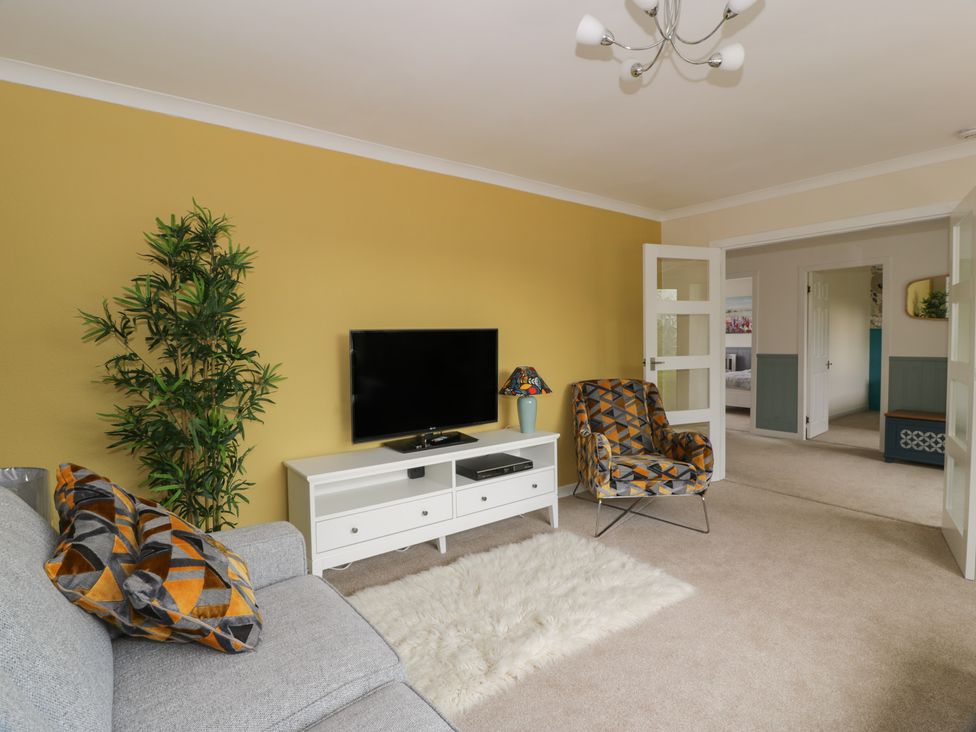 A living room with a sofa and television at The Rowans in 