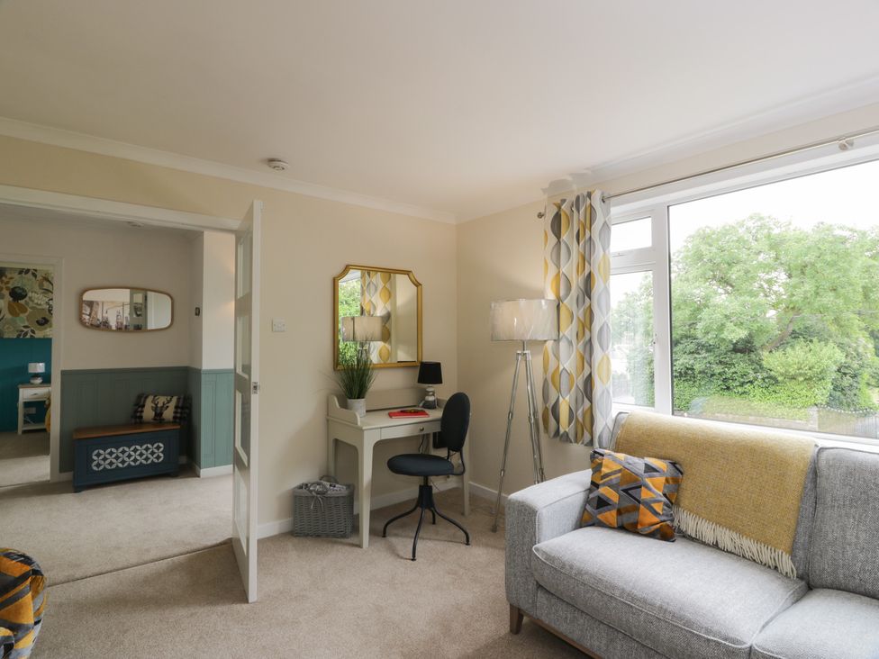 A living room with a desk and chair at The Rowans in 