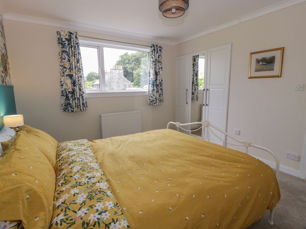 A bedroom with a bed and window at The Rowans in 