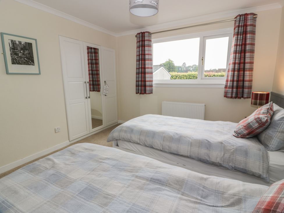 A bedroom with two beds and a window at The Rowans 
