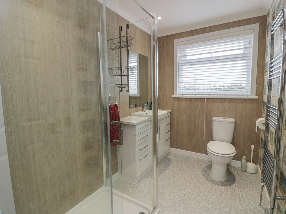 A bathroom with a shower, sink, and toilet at The Rowans in 