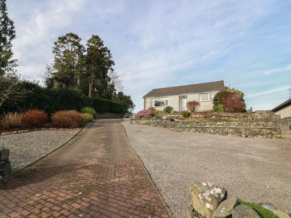 A house with a driveway and garden areas at The Rowans in 