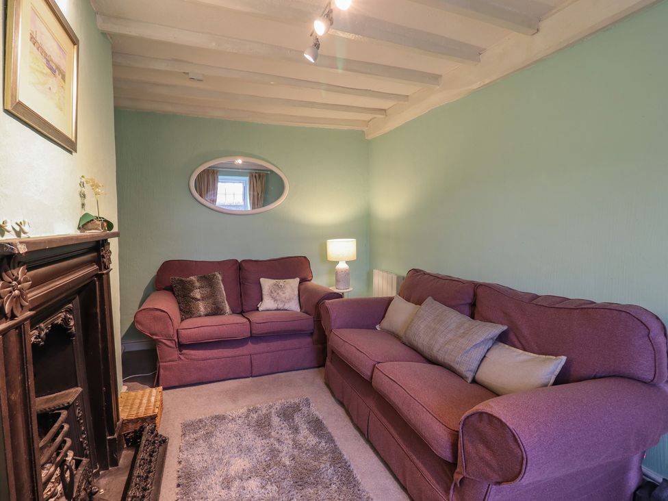 A living room with two sofas and a lamp at Preswylfa in Ffestiniog