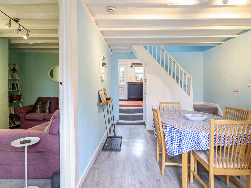 A dining room with a table and chairs at Preswylfa in Ffestiniog