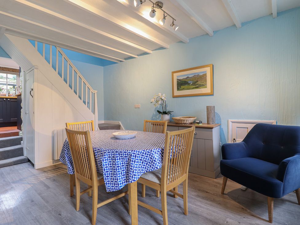 A dining room with a table and chairs at Preswylfa in Ffestiniog