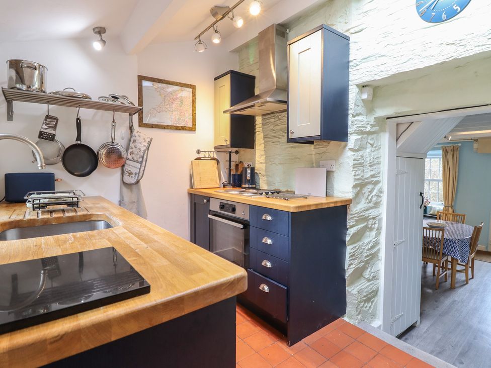 A kitchen with a sink, stove, and oven at Preswylfa in Ffestiniog