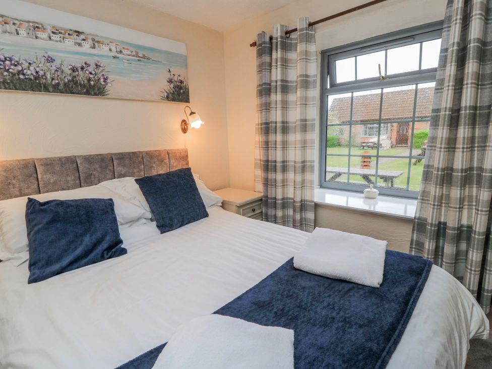 A bedroom with a bed and curtains at Carthouse in Brean