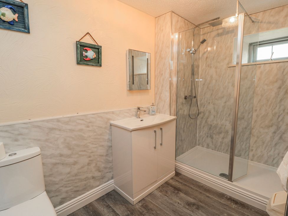 A bathroom with a toilet, sink, and shower at Carthouse in Brean