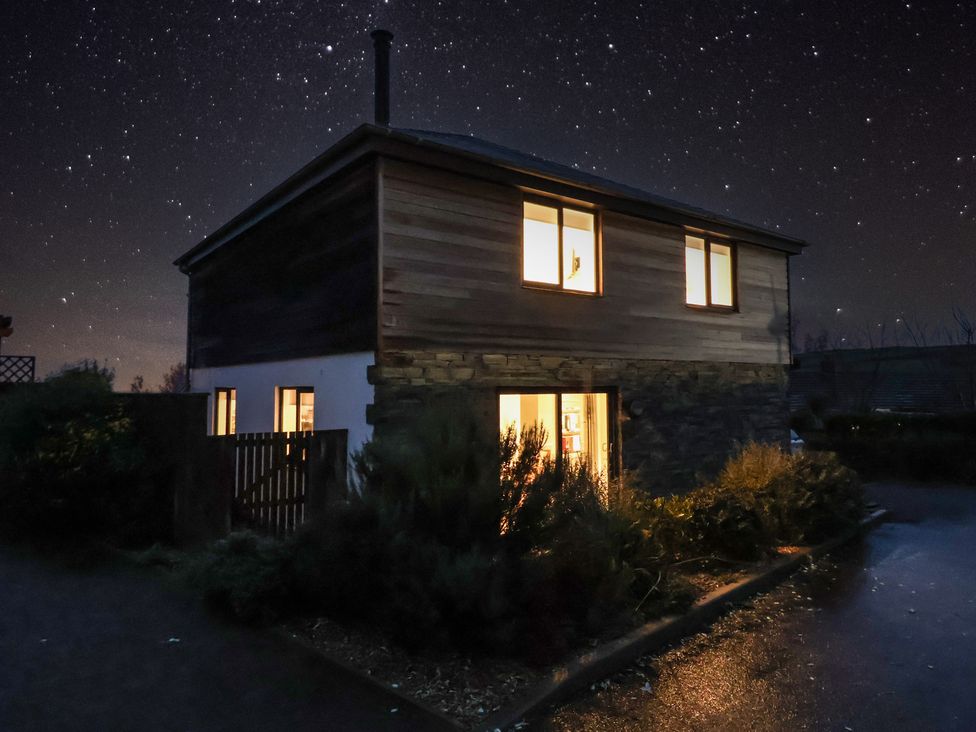 A house with lights on at night at 3 Praa Cove in Praa Sands