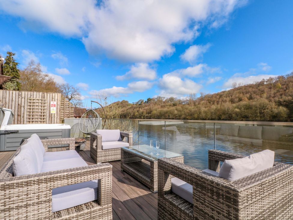 An outdoor seating area overlooking water at The Bothy in Leek
