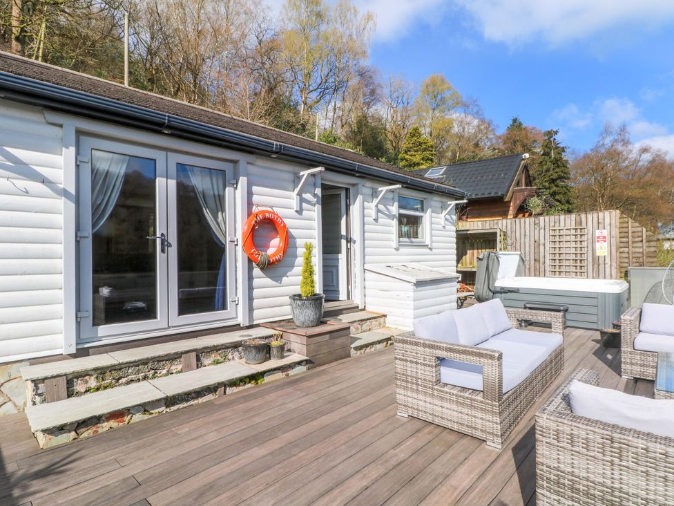 An outdoor area with seating and a hot tub at The Bothy in Leek