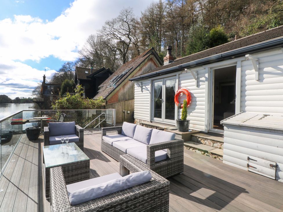 An outdoor deck with sofas and a table at The Bothy in Leek