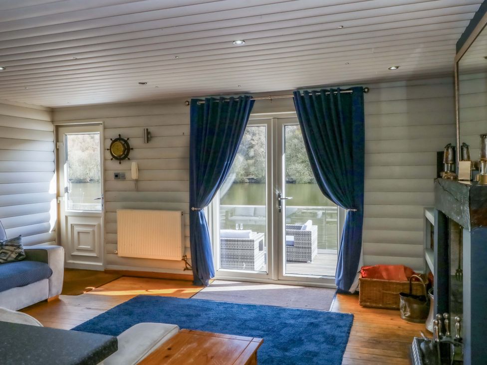 A living room with a sofa and door leading to the outside at The Bothy in Leek