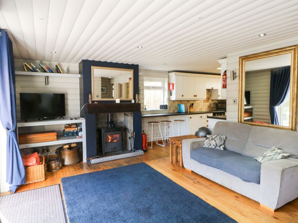 A living room with a fireplace and sofa at The Bothy in Leek
